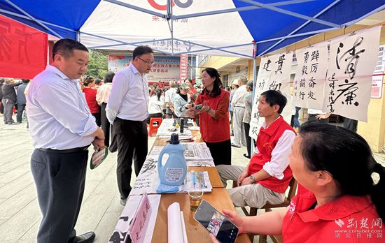 “文化惠民”攤位上，志愿者展示書法作品_副本.jpg